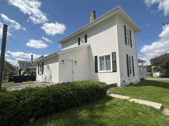 301 Plumvalley St, Bellefontaine, OH 43311 - back of house featuring a chimney and a yard