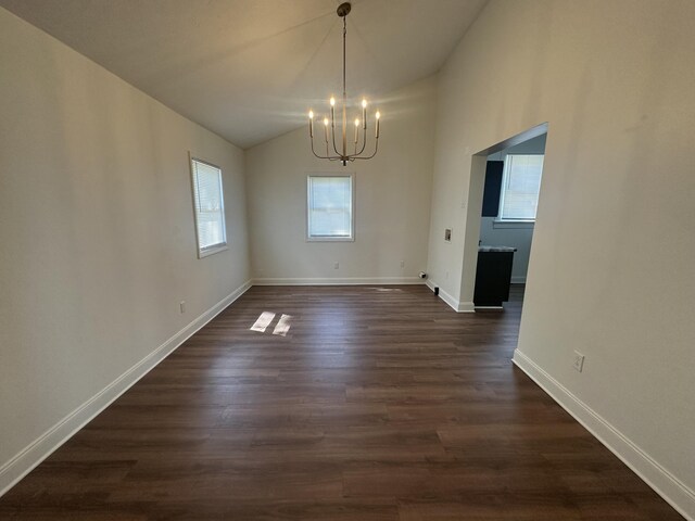 301 Plumvalley St, Bellefontaine, OH 43311 - unfurnished dining area featuring a chandelier, dark wood-style flooring, lofted ceiling, and baseboards