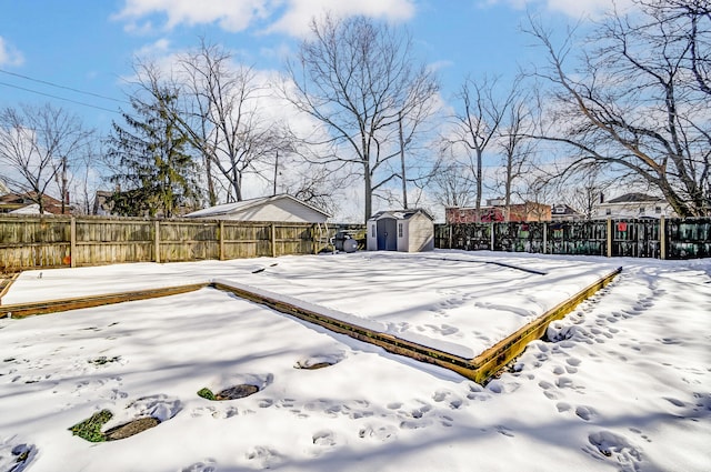 snowy yard with a storage unit