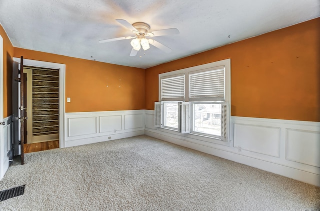 carpeted empty room with ceiling fan