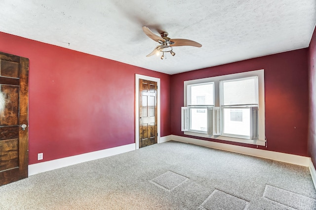 unfurnished room with ceiling fan, carpet floors, and a textured ceiling