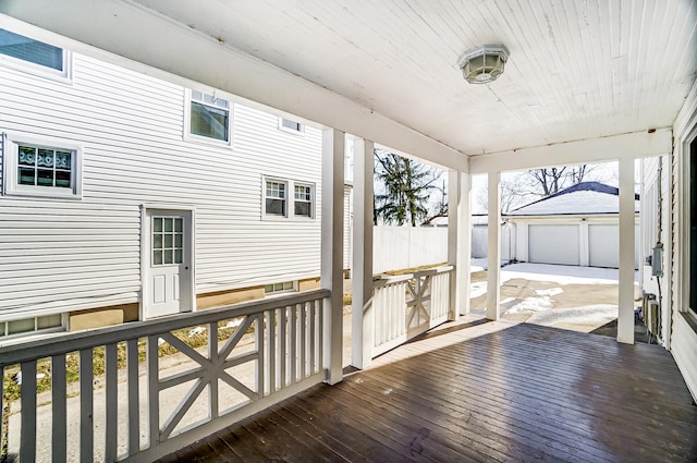 wooden deck with a garage and an outdoor structure