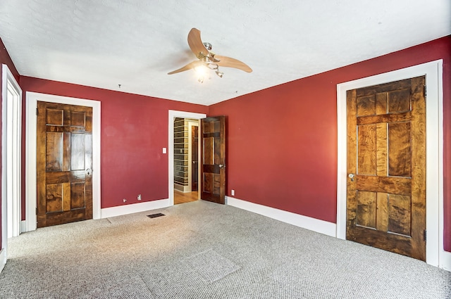 unfurnished bedroom with ceiling fan and carpet floors