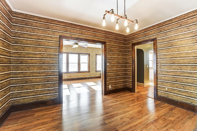 empty room featuring crown molding and hardwood / wood-style flooring