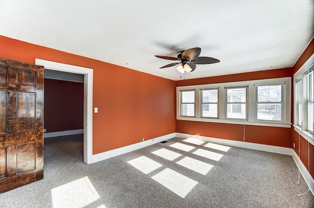 empty room featuring ceiling fan and carpet floors