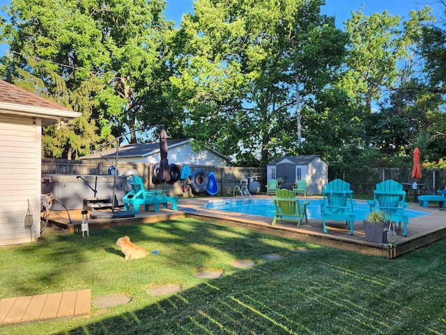 view of yard featuring a pool side deck and a storage shed