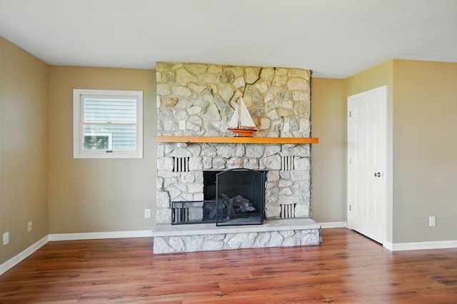 9113 Lake Ave, Huntsville, OH 43324 - unfurnished living room featuring wood finished floors and a fireplace