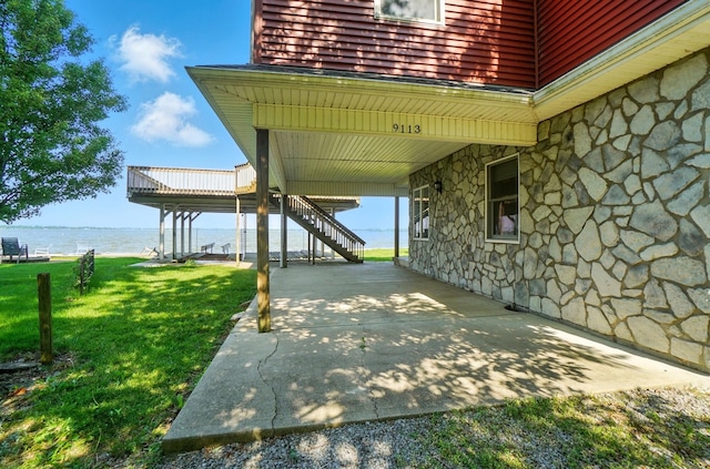 9113 Lake Ave, Huntsville, OH 43324 - view of patio / terrace with a water view and stairway