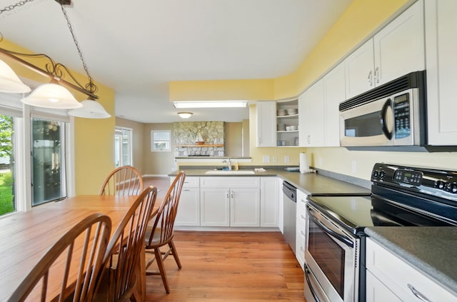 9113 Lake Ave, Huntsville, OH 43324 - kitchen with appliances with stainless steel finishes, white cabinetry, light wood finished floors, and open shelves