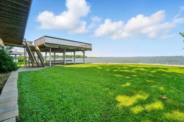 9113 Lake Ave, Huntsville, OH 43324 - view of grassy yard featuring stairs and a deck with water view