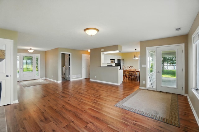 9113 Lake Ave, Huntsville, OH 43324 - unfurnished living room with wood finished floors and baseboards