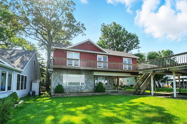 9113 Lake Ave, Huntsville, OH 43324 - rear view of house with stone siding, stairs, a lawn, and a wooden deck