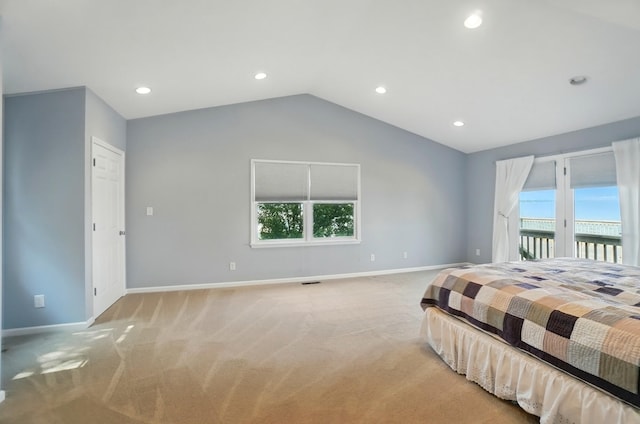 9113 Lake Ave, Huntsville, OH 43324 - bedroom with access to exterior, light carpet, multiple windows, vaulted ceiling, and recessed lighting