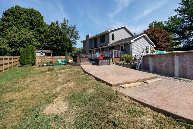 view of yard featuring a deck and a patio area