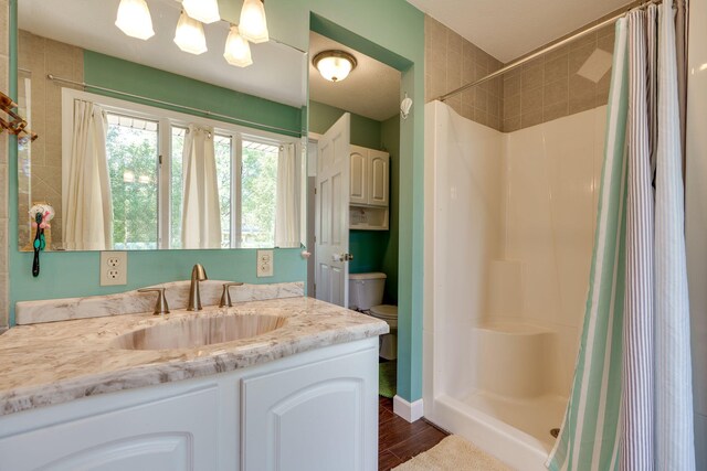 bathroom featuring vanity, toilet, a shower with shower curtain, and wood-type flooring