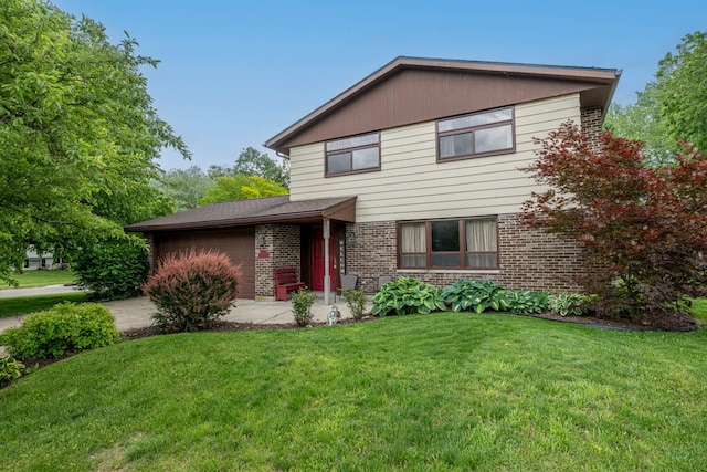 5154 Saum St, Fairborn, OH 45324 - traditional home featuring brick siding, a front lawn, and an attached garage