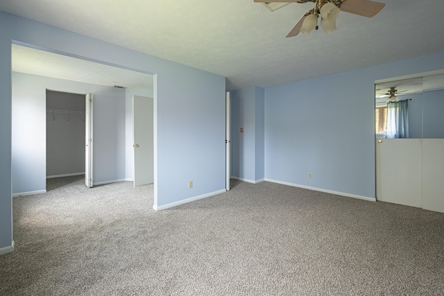 spare room featuring baseboards, a ceiling fan, and carpet flooring