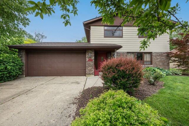 5154 Saum St, Fairborn, OH 45324 - traditional-style home with brick siding, a garage, and driveway