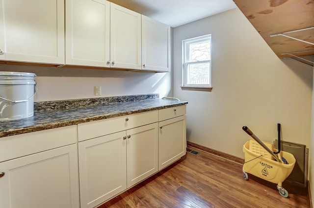 washroom featuring baseboards and wood finished floors