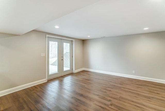 spare room with baseboards, wood finished floors, and french doors