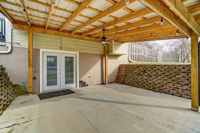 view of patio with french doors and fence