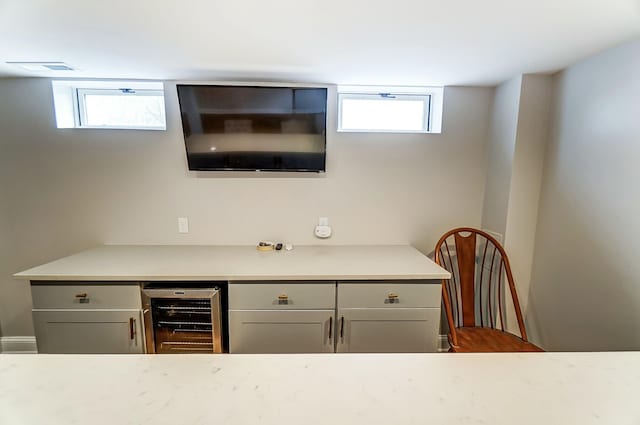 bar with beverage cooler and visible vents