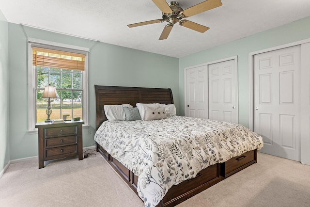 1686 Laurel Creek Dr, Troy, OH 45373 - bedroom featuring light carpet, two closets, and ceiling fan
