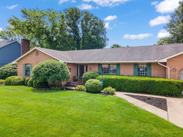 1686 Laurel Creek Dr, Troy, OH 45373 - ranch-style home with brick siding, a front yard, a shingled roof, and a chimney