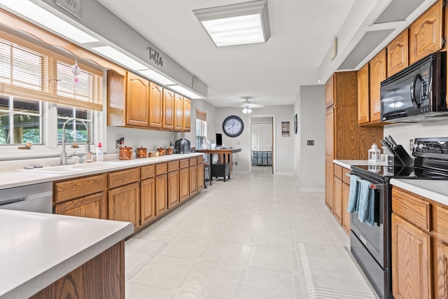 1686 Laurel Creek Dr, Troy, OH 45373 - kitchen featuring appliances with stainless steel finishes, light countertops, light floors, brown cabinetry, and a ceiling fan