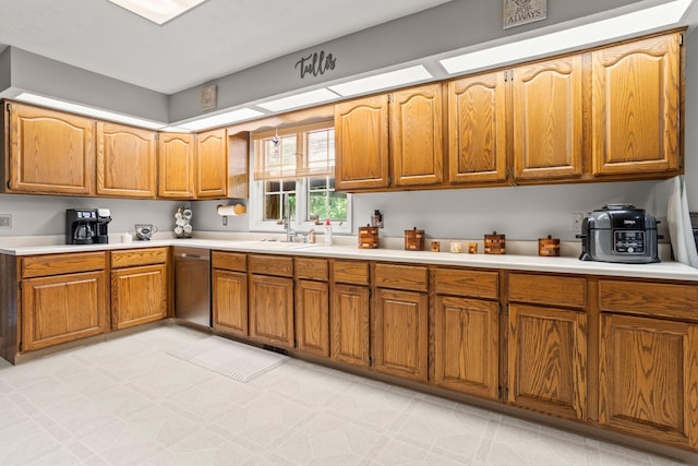1686 Laurel Creek Dr, Troy, OH 45373 - kitchen featuring dishwasher, light countertops, and brown cabinetry