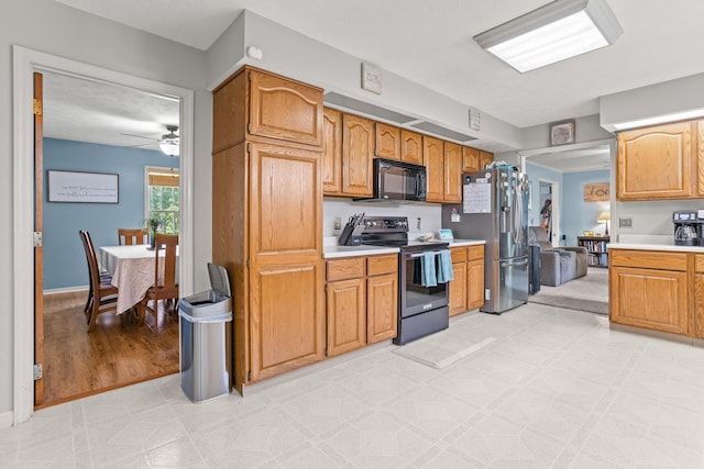1686 Laurel Creek Dr, Troy, OH 45373 - kitchen with range with electric cooktop, black microwave, stainless steel fridge, light countertops, and a ceiling fan