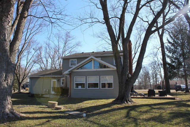 view of side of property featuring a yard and a patio area