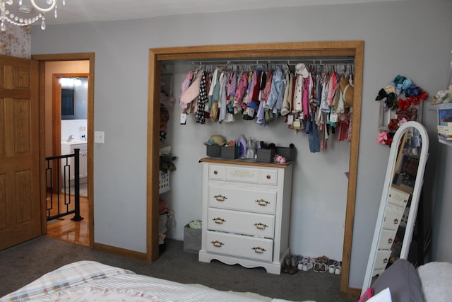 bedroom featuring a sink, a closet, and carpet flooring