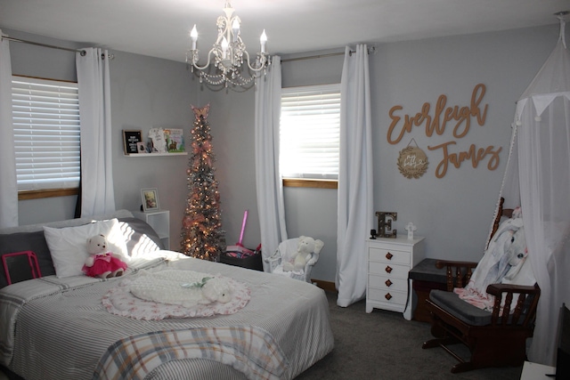 carpeted bedroom featuring an inviting chandelier