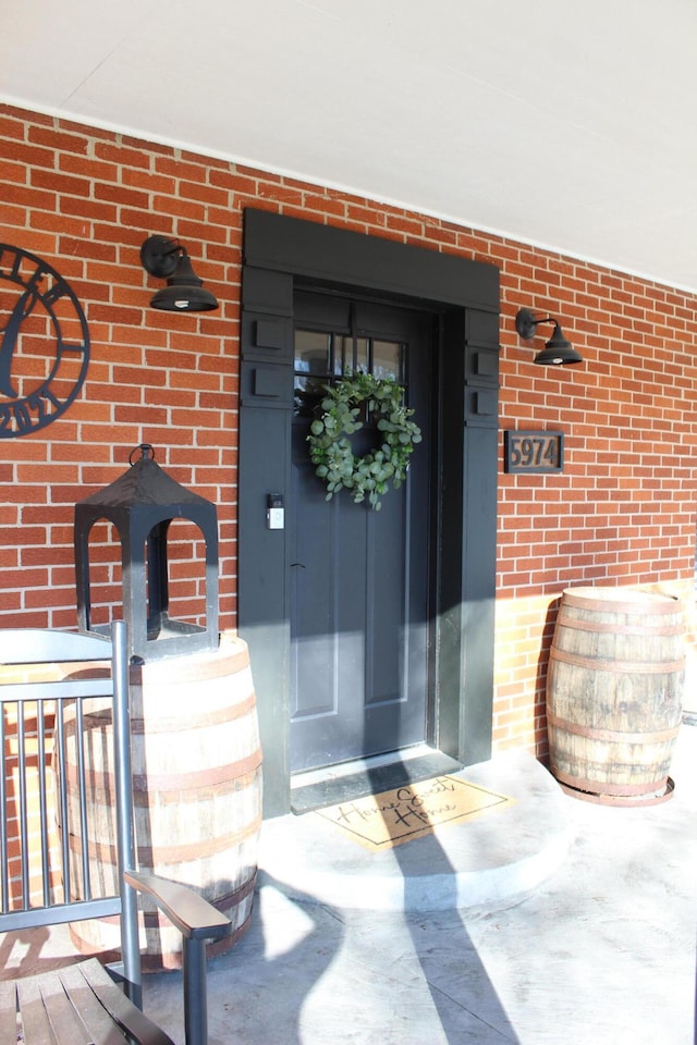 view of exterior entry with brick siding