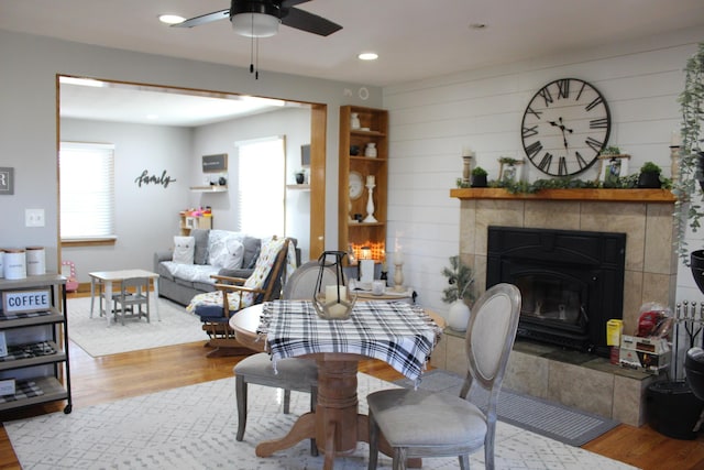 living room featuring recessed lighting, wood finished floors, a ceiling fan, and a tile fireplace