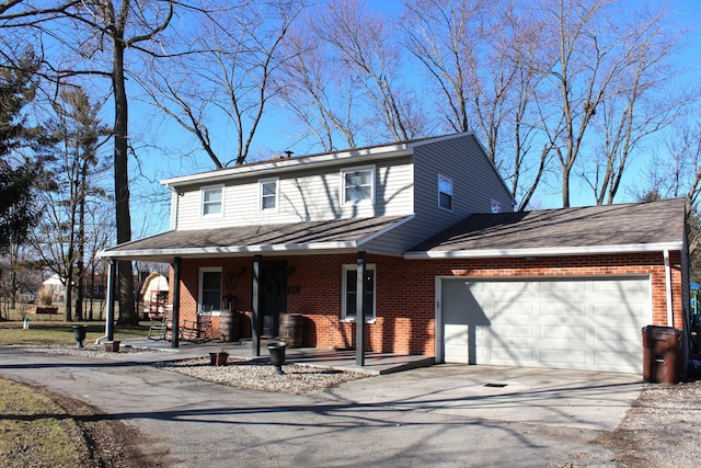 view of front of property featuring brick siding, a shingled roof, a porch, a garage, and driveway