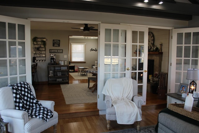 living room featuring french doors, ceiling fan, and wood finished floors