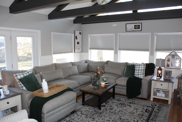 living room featuring plenty of natural light, wainscoting, vaulted ceiling with beams, and wood finished floors