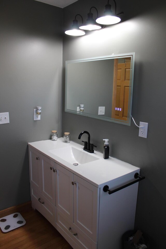 bathroom featuring wood finished floors and vanity
