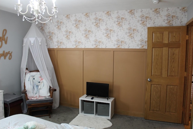bedroom featuring wallpapered walls, a notable chandelier, light colored carpet, and wainscoting