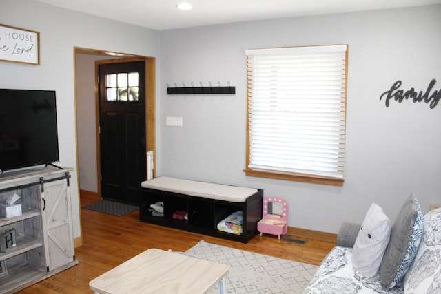 living area with recessed lighting, baseboards, and light wood-style floors