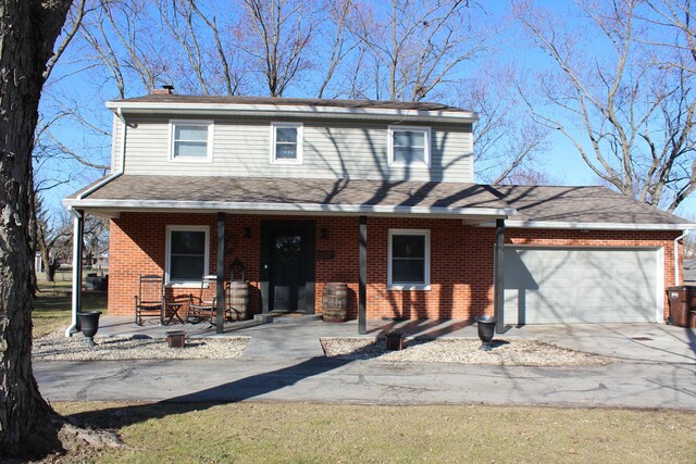 view of front facade with driveway, brick siding, covered porch, and an attached garage