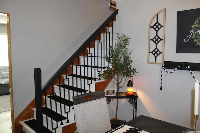 stairs featuring wood finished floors