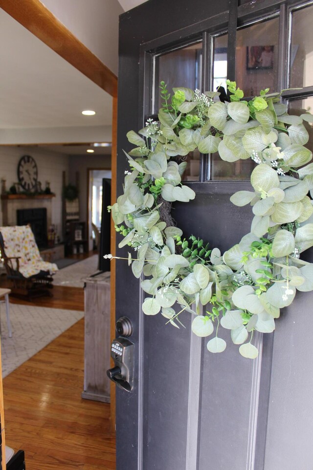 details featuring recessed lighting, wood finished floors, and a fireplace