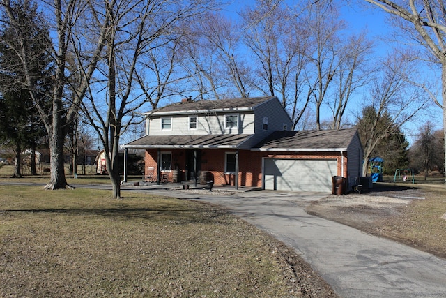 view of front facade featuring aphalt driveway, a front yard, brick siding, and an attached garage