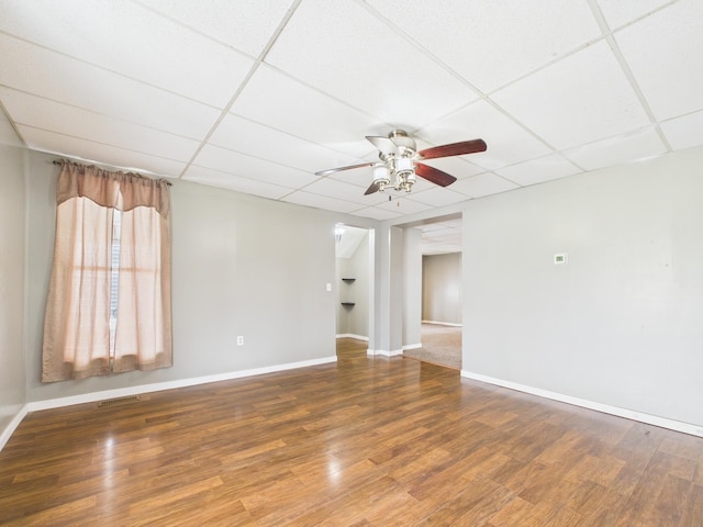 spare room featuring wood finished floors and a drop ceiling