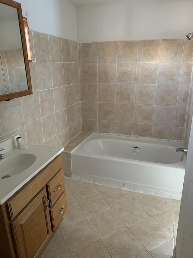 bathroom featuring vanity, bathing tub / shower combination, tile patterned floors, and tile walls