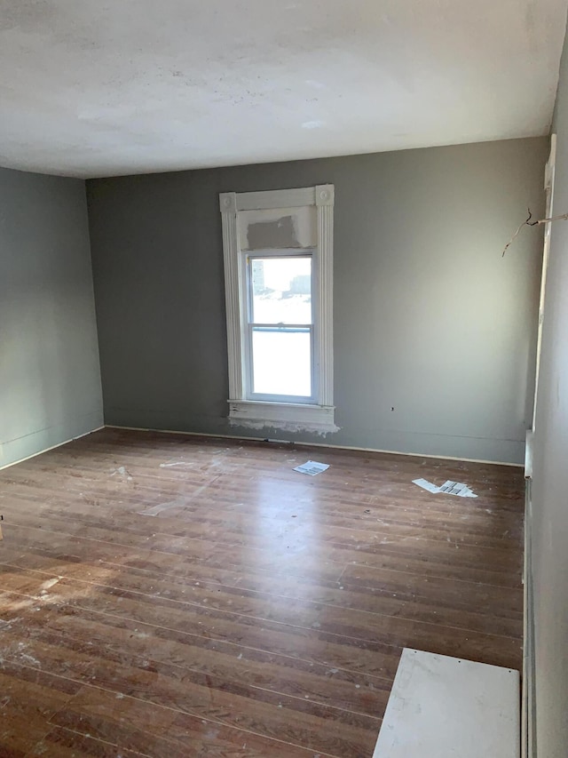 spare room featuring dark hardwood / wood-style flooring