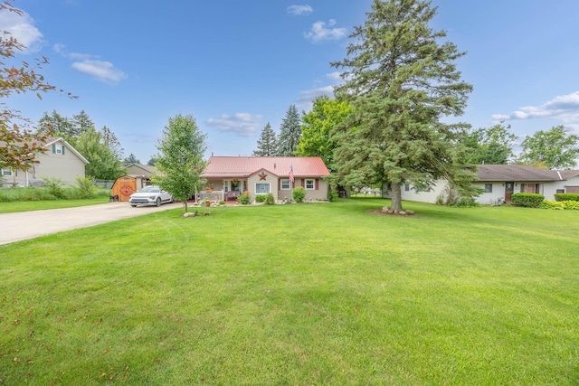 844 Reservoir Rd, Bellefontaine, OH 43311 - ranch-style home featuring concrete driveway, a front lawn, a metal roof, and covered porch